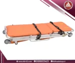 Orange Saikang ambulance trolley in folded position with detachable stretcher, fluid-resistant mattress, 4 wheels with brakes