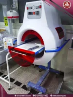 Real image of Neonatal jaundice treatment capsule with 16 LED lights, white body, red cover, blue mobile base, and digital screen