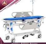 White Saikang fiber trolley with low side rail, flat backrest, blue mattress, oxygen holder, IV pole, and 5 wheels
