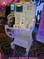 A natural, front-angle view of a white digital anesthesia machine on a four-wheel base with a 10-inch touchscreen.