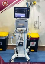 Operating room image of MEK MV2000 EVO 5 ventilator with 15-inch TFT touch screen, white design on four-wheel base.