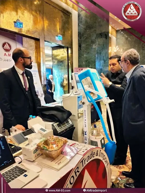 AM For Trade & Import Company team presenting and explaining the features of a white and blue ventilator with a touchscreen display to a specialist doctor during the conference