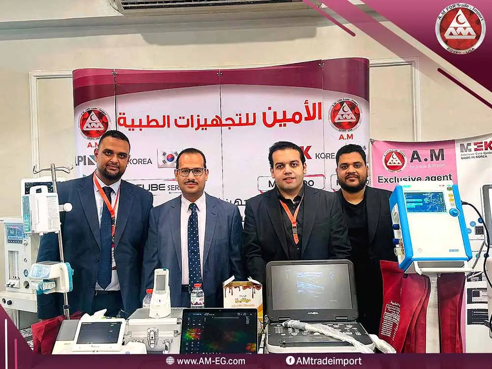 Four Al-Amin Medical Equipment representatives at a trade exhibition booth showcasing Korean-made ventilators, ultrasound machines, and patient monitors.