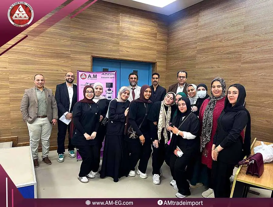 AM for Trade & Import team during an educational medical event inside a conference hall, standing beside the Alpinion Medical Systems ultrasound exhibition booth in Egypt.
